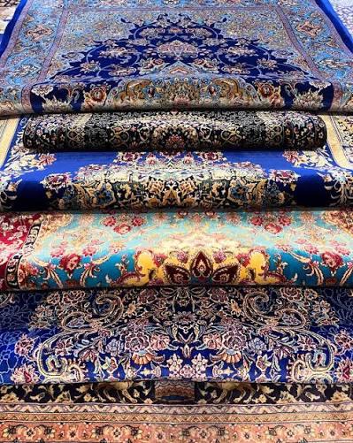 Silk rug catching light across its pile